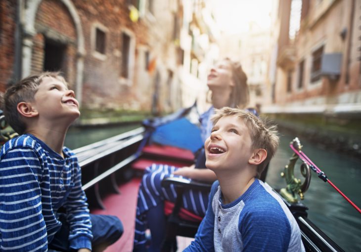 Kids enjoying gondola ride in Venice, Italy